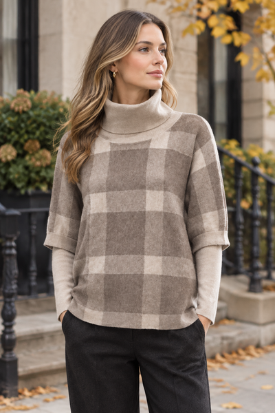 Beige plaid poncho sweater on a female model