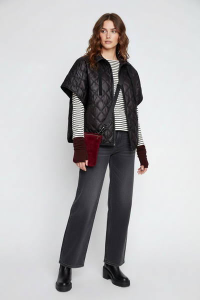 Black zipper-front quilted poncho on the alternate female model, close-up