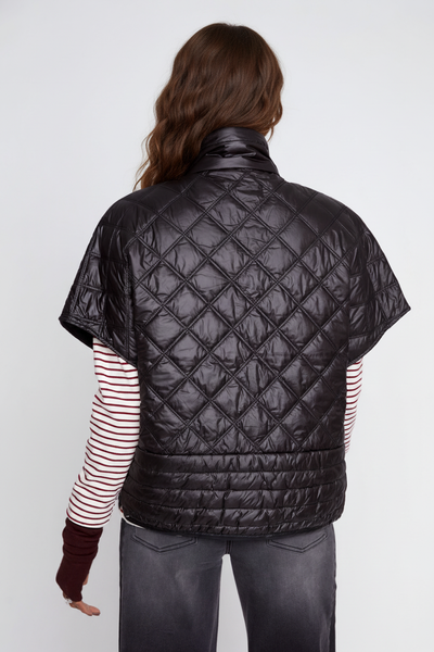 Black zipper-front quilted poncho on the alternate female model, back view