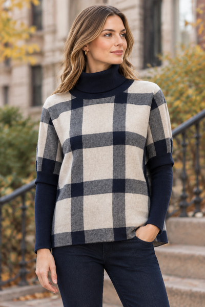 Navy plaid poncho sweater on a female model